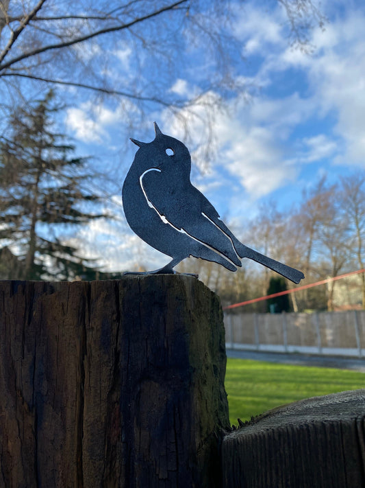 metal song thrush bird mounted to a fence post for a garden decoration