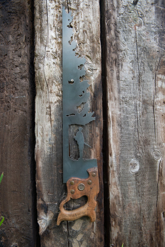 decorative vintage saw with a hunter in the woods