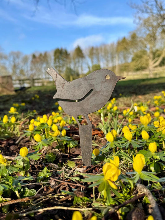 Steel garden decoration pot spike of a wren surrounded by yellow flowers