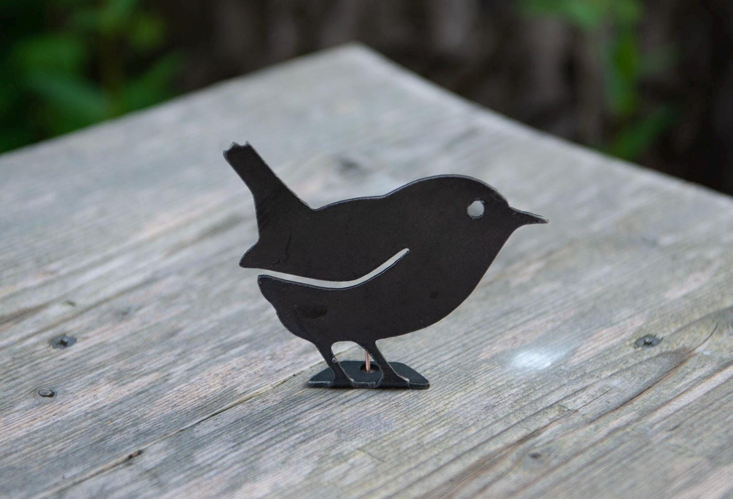 metal wren attached to a garden fence for decoration