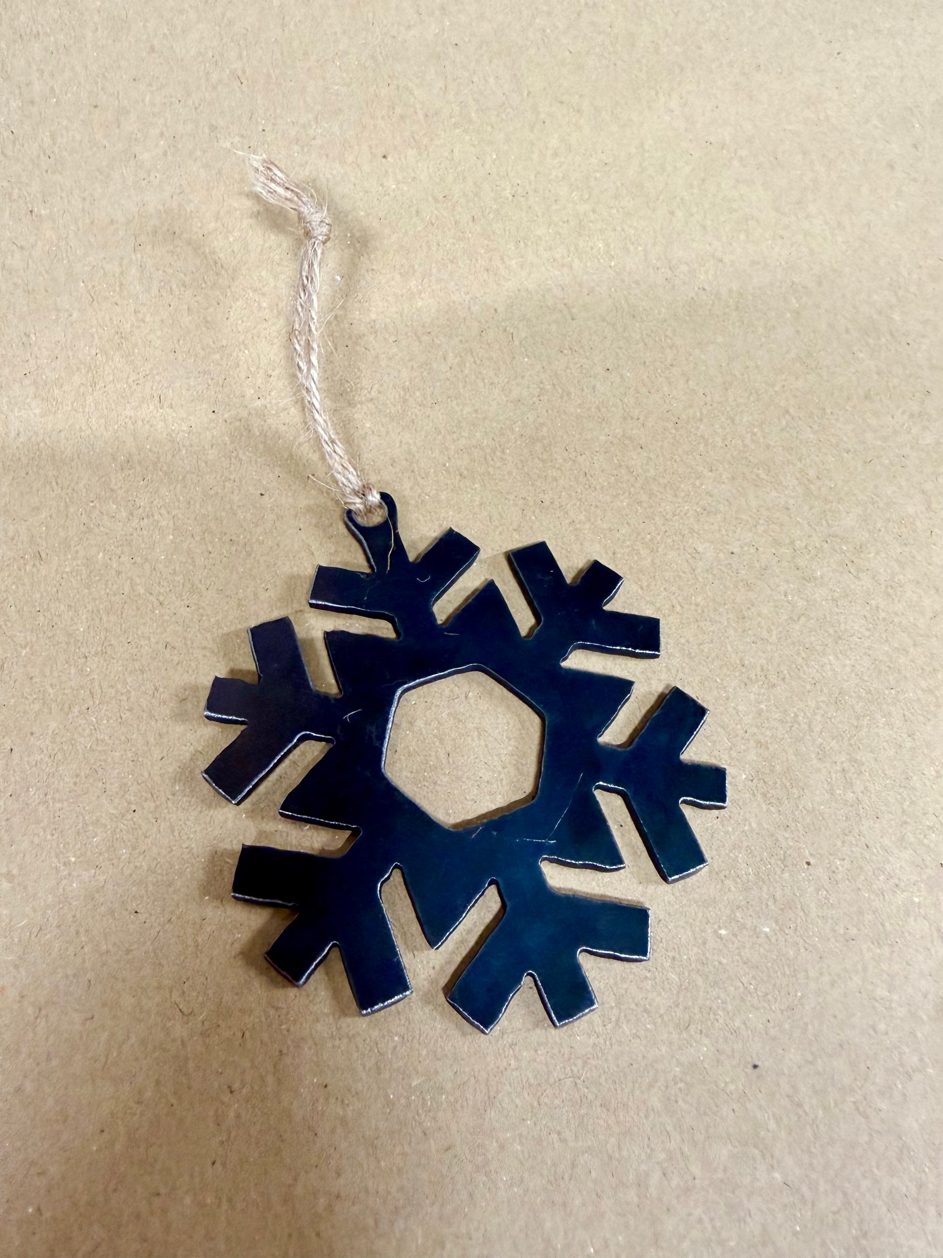 Steel Snowflake Christmas decoration with string attached for hanging.