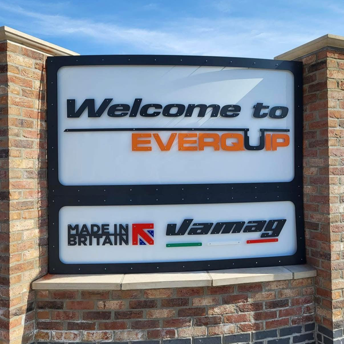 A large curved sign that says welcome to everquip, made in Britain and Vamag. It has the Everquip Logo, the Union Jack and the Italian flag. 