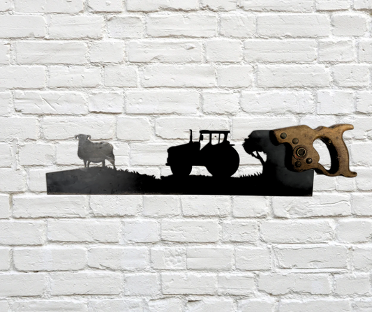 Decorative vintage saw with tractor and sheep design on a white brick wall.