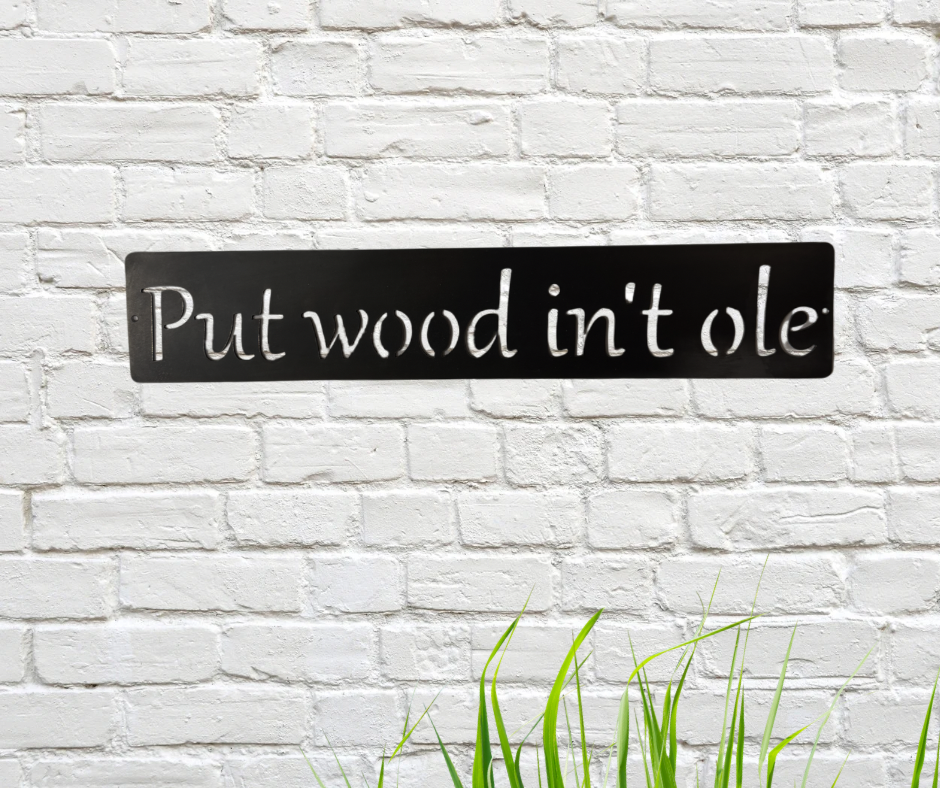 Metal sign with white text 'Put wood in't ole' on a white brick wall background.