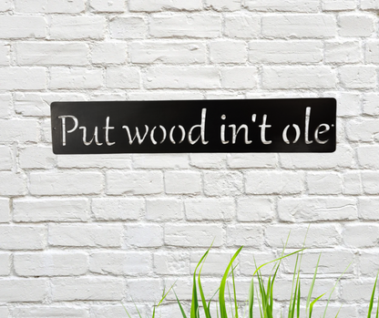 Metal sign with white text 'Put wood in't ole' on a white brick wall background.