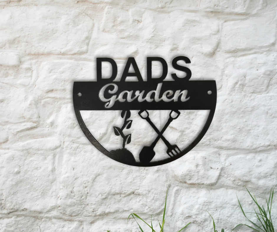 Metal sign with 'DADS Garden' text on a stone wall background
