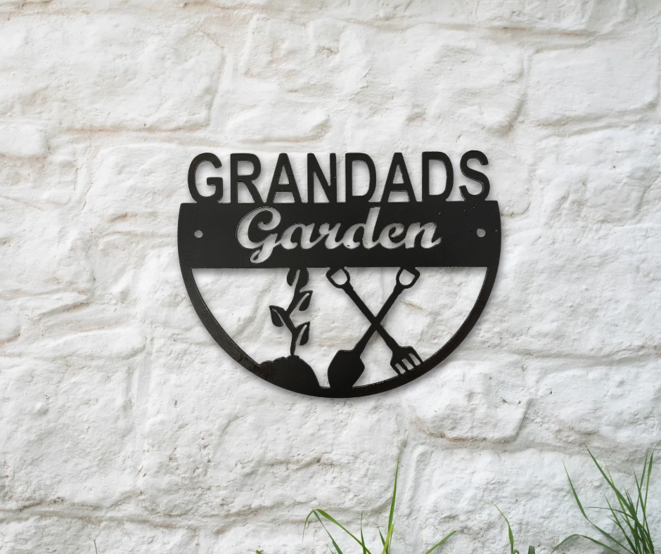 Decorative metal sign with 'Grandad's Garden' text on a stone wall.