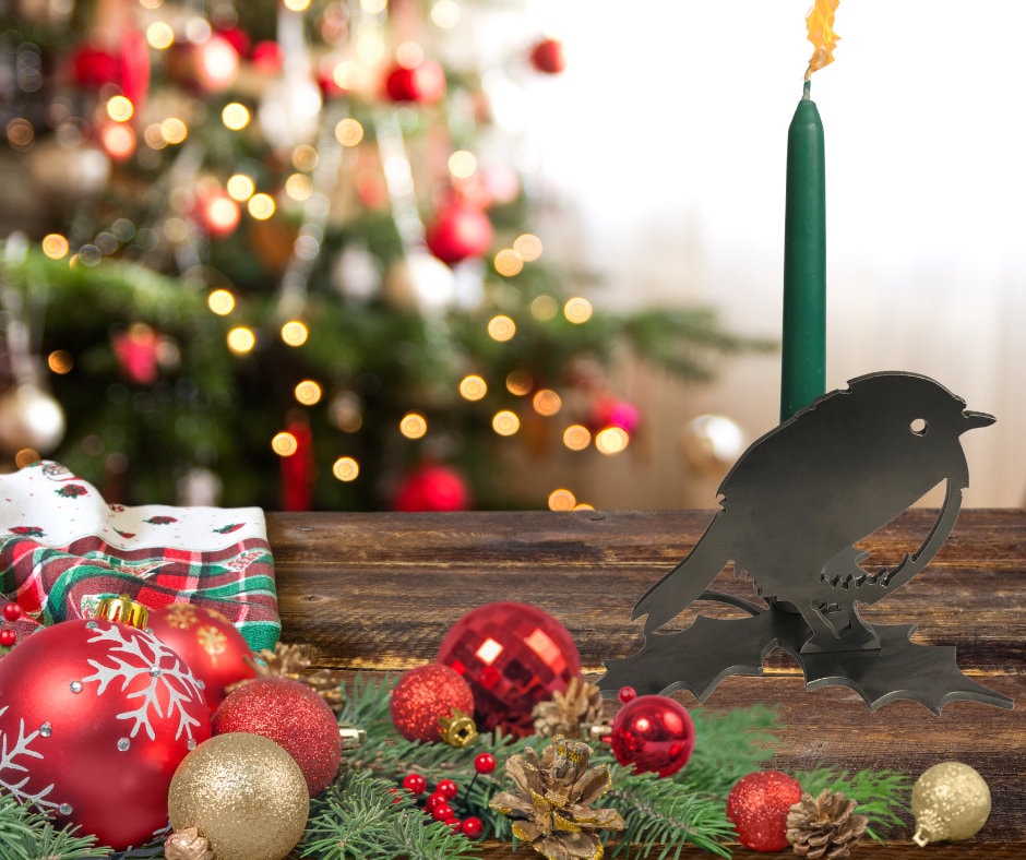 Decorative Robin candle holder Christmas ornaments and tree in the background.